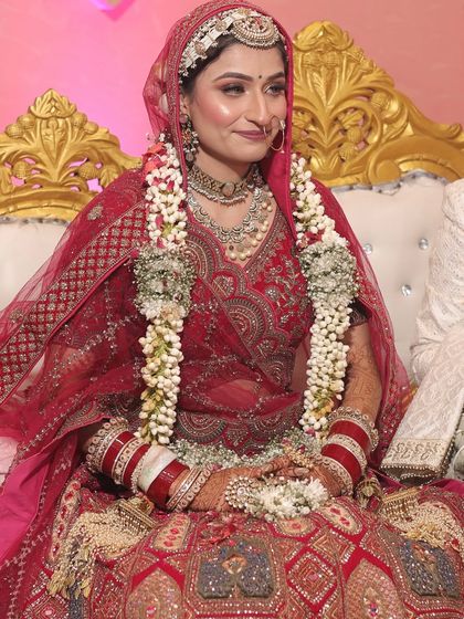 My bride Varsha seated on her wedding day, looking serene and beautiful. The makeup is soft and elegant, designed to last through the long ceremony.