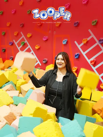 Playing with the soft foam blocks in front of our climbing wall. It's a space for both adventure and imaginative play.