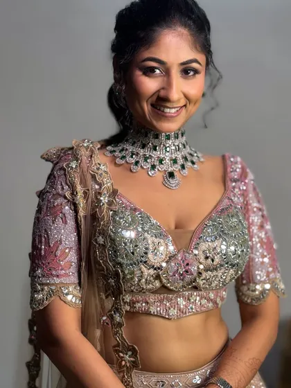 A full view of the reception blouse and jewelry. The makeup is kept soft and glowing to balance the intricate, heavy work on the lehenga.