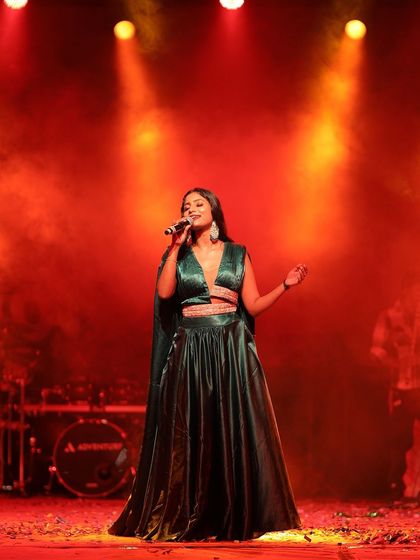 The full stage view shows how the outfit stands out. The colour, cut, and fabric all come together to create a memorable look.