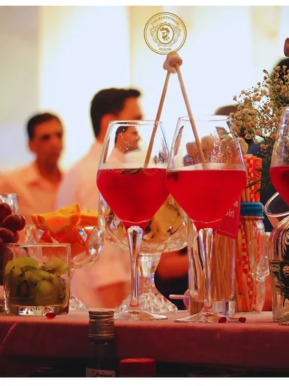 A pair of our signature red wine cocktails, garnished with fresh fruits and herbs. Perfect for a sophisticated evening event.