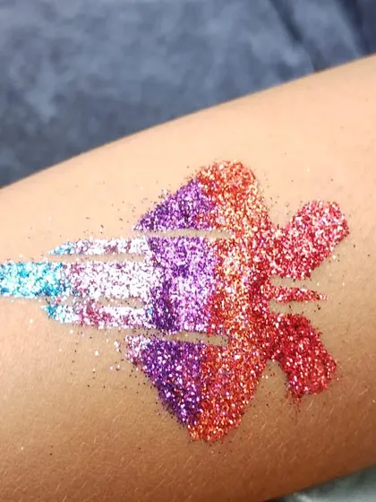 A multi-colored jet fighter tattoo. I can customize the colors in my designs to match any theme, including superheroes or military themes.