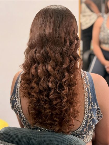 A back view of the beautiful, defined curls created for this look. In my hairstyling course, you'll learn how to use different tools to create various types of curls.