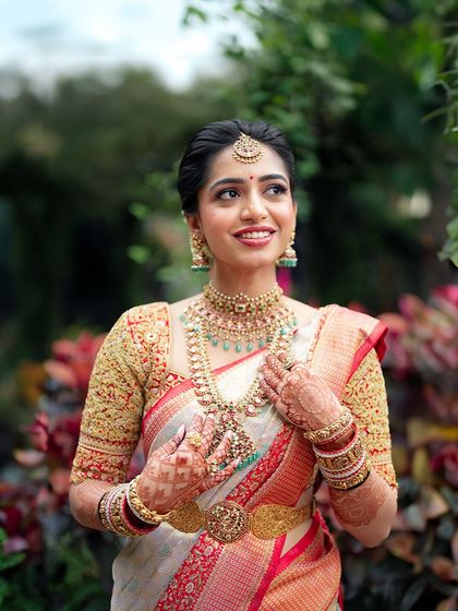 A happy, smiling portrait of the bride in an outdoor setting. The natural light makes her skin look fresh and luminous.