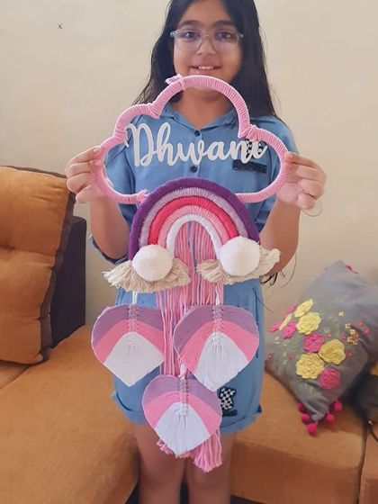 The 'Dhwani' nameplate, held up to show its full size and design. It's a substantial piece that makes a beautiful statement in a room.