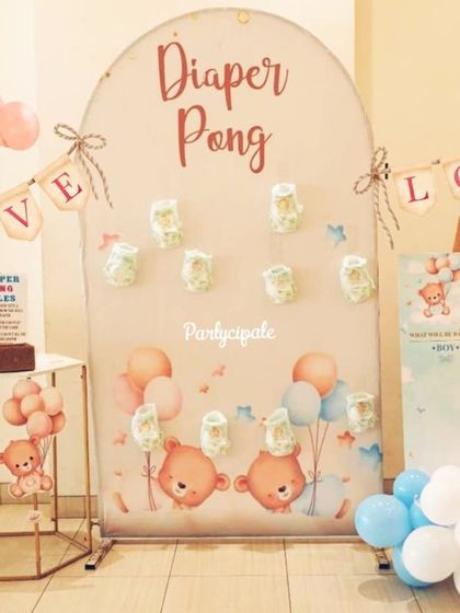 Fun and games at the baby shower. We set up a 'Diaper Pong' game and a 'He or She' gender reveal board to entertain the guests and add an interactive element to the celebration.