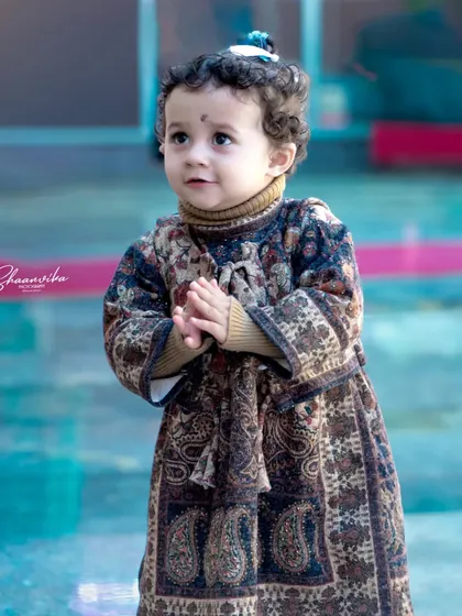 A candid shot of a toddler with an innocent, thoughtful expression. I love capturing these quiet, in-between moments during a children's portrait session.