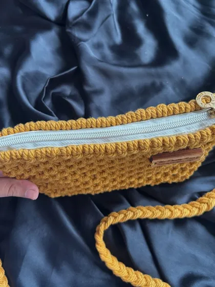 A look inside our mustard yellow bag, showing the zipper closure that keeps your belongings safe. We focus on both aesthetics and functionality in our designs.