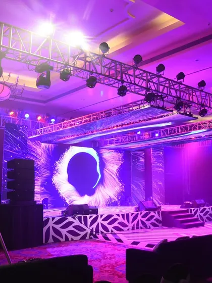 The stage for this Sangeet was designed for a high-energy performance, with a massive LED screen, professional truss lighting, and a patterned stage floor.