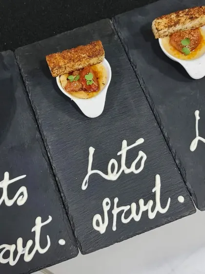"Let's Start." A creative way we presented our amuse-bouche of gazpacho with a crouton. It's these little touches that make our sit-down dinners special.