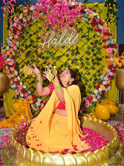 Another beautiful moment from the same Haldi ceremony, with the bride surrounded by a circle of multi-colored flowers. I love creating spaces that result in such happy, candid photos.