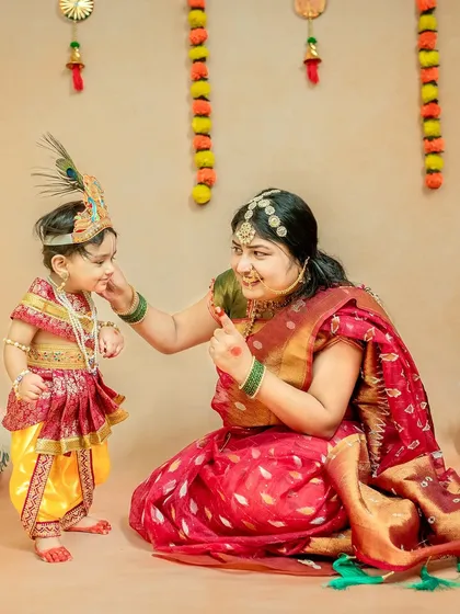 A playful interaction between mother and child, as Yashoda lovingly teases her little Kanha.