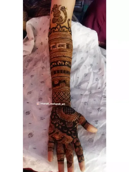 A traditional arm design featuring rows of elephants and a 'Sai Baba' inscription. This style is often requested for its cultural and spiritual significance.