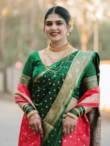 A lovely portrait of the bride, showcasing her complete traditional look. Her happy and welcoming expression makes this a warm and inviting photograph.