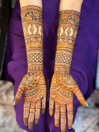 Another view of a full-coverage bridal design with repeating bands of patterns. The consistency and detail create a beautiful, flowing look up the arms.