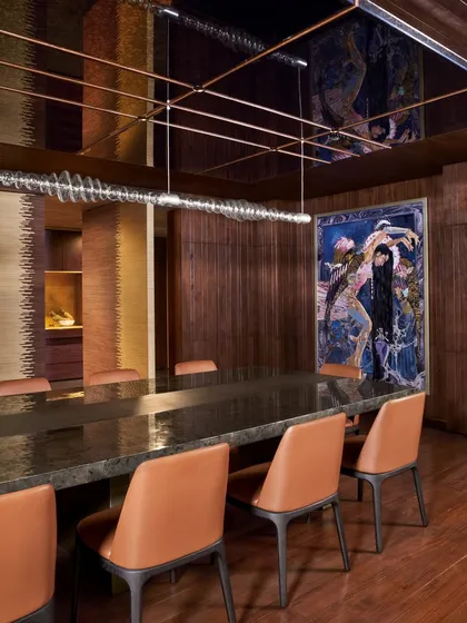 The dining room at the Baid Residence, featuring a Red Dot Award-winning light fixture and captivating artwork by Shilo Shiv Suleman. The space is designed for an elevated, artistic dining experience.