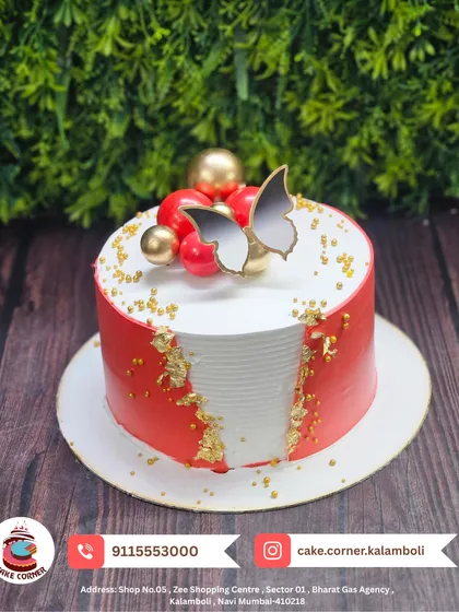 An elegant red and white cake with butterfly and sphere decorations. The fault line design with gold leaf adds a modern and sophisticated touch.