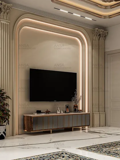 The TV wall in the grand bedroom is framed by classic molding and backlit panels, seamlessly integrating modern technology into a classically inspired space.