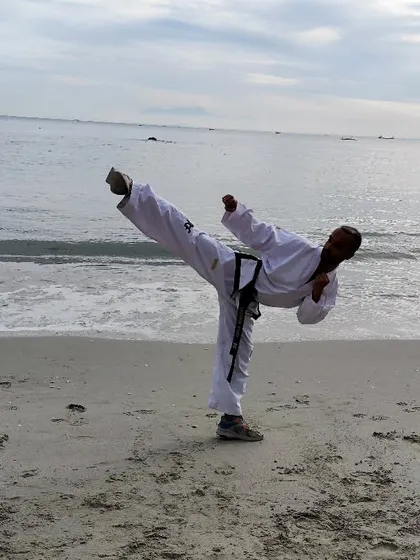 A side kick on the beach in Penang, Malaysia. Training in different settings helps improve balance and adaptability, core skills for any martial artist.