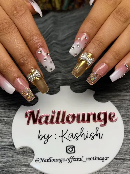 The ultimate bridal bling. This set features a mix of gold chrome, white ombre, and glitter nails, all adorned with 3D bows, rhinestones, and gold flakes for a truly show-stopping look.