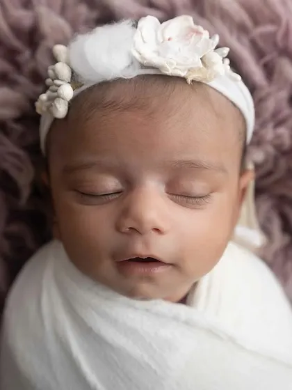 The serene face of a sleeping newborn. My goal is to capture this fleeting stage with grace and beauty.