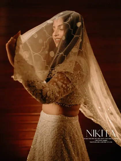 A bride's portrait is a story in itself. Here, Nikita's gentle smile under the delicate veil captures a moment of quiet anticipation and timeless elegance before she walks towards her forever.