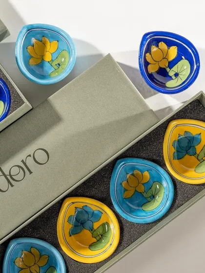 Doro's ceramic diyas being unboxed from an elegant gift box. This shot showcases the product as a premium gift item, perfect for festive occasions.