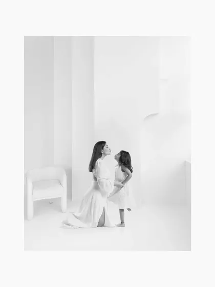 The black and white version of the mother-daughter portrait, emphasizing the emotional connection and timeless quality of their bond.