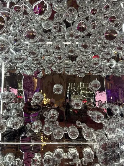 When the entrance is a walkway full of silver funk and visual magic. This immersive installation of silver bubbles and mirrors set the tone for a disco-themed night.