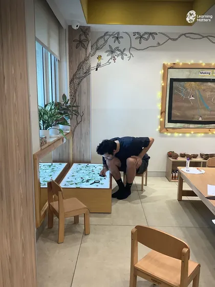 Parents get hands-on with the same sensory materials their children use. This shared exploration at the light table fosters empathy and gives parents a direct window into the power of play-based learning.