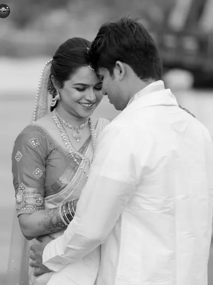 A timeless black and white portrait captures a quiet, intimate embrace between a bride and groom. This style of photography focuses purely on emotion and connection, creating classic images that will never go out of style.