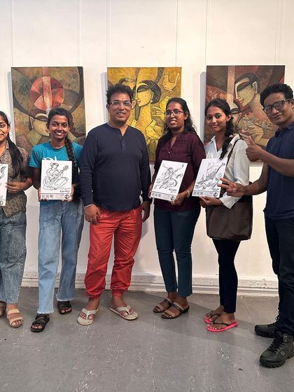 Some happy visitors at my international exhibition in Colombo, each holding their own piece of signature art that I created for them.