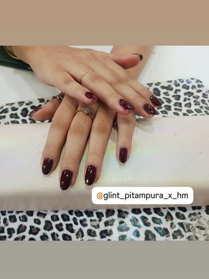 This client chose a deep, rich burgundy gel polish for her almond-shaped nails. This classic color is perfect for autumn and winter, or for anyone who loves a bold yet elegant manicure.