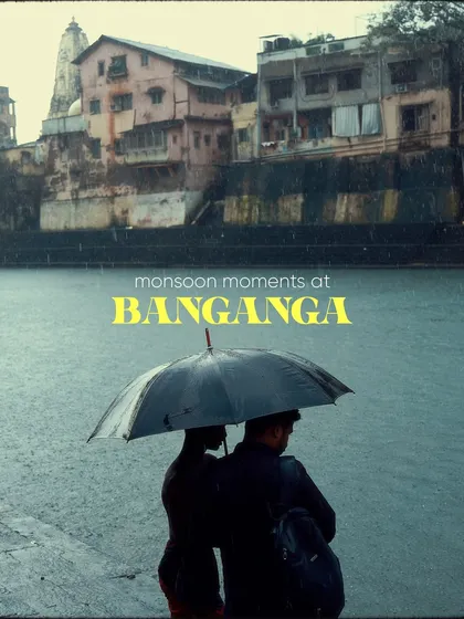 A couple stands together under an umbrella at the edge of Banganga Tank. This image, with its title overlay, serves as the introduction to a series of moments captured at this historic and spiritual spot during the rains.