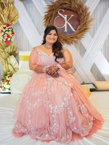A seated portrait of the bride against the event decor, looking like a princess.