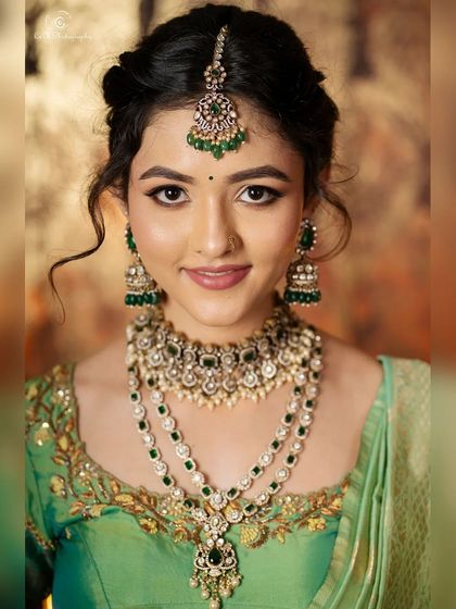 Another detailed shot of the traditional styling, focusing on the layered necklaces, maang tikka, and flawless makeup.