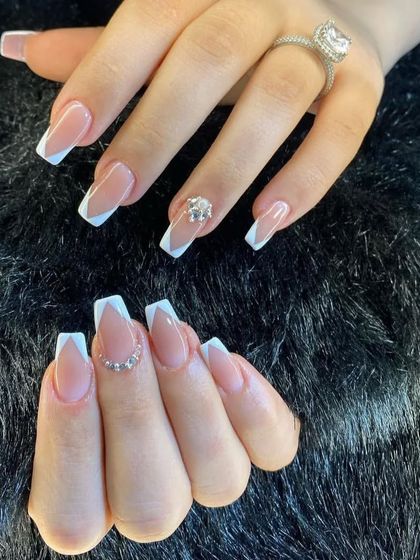 This V-French manicure on long coffin nails includes delicate rhinestone accents for an extra special touch.
