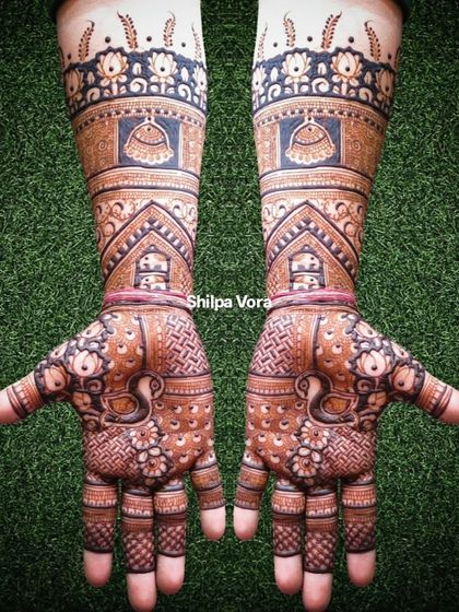 The full-arm bridal design against a green background, showing how it looks in natural light.