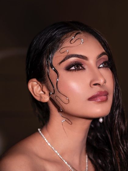 A different angle from the wet-look series, capturing a moment of quiet contemplation. The light catches the moisture on her skin and the delicate pearl details in her hair.