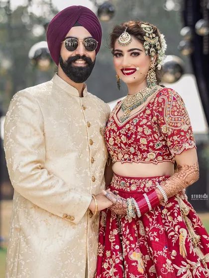 The perfect couple portrait. Her makeup is flawless, with bold red lips and defined eyes that photograph beautifully.