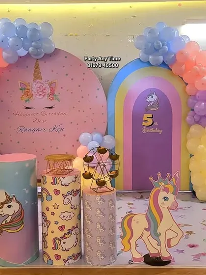 This full setup for a unicorn party includes a rainbow arch, a large circular backdrop, themed pedestals, and balloon clouds. I can transform any space into a fantasy land for your child.