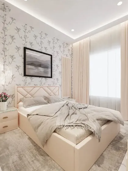 For this bedroom, we chose a subtle floral wallpaper to create a calm and serene backdrop. The design is complemented by a simple upholstered headboard and soft, diffused lighting from the ceiling and curtains.