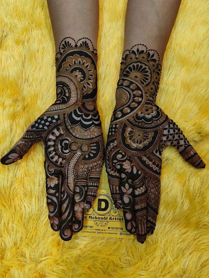 A classic Indo-Western design with a mix of paisleys, floral motifs, and geometric patterns, covering the hand beautifully.