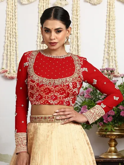 A detailed view of the front of the red blouse, showing the intricate sequin and thread embroidery.