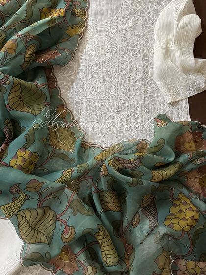 Another view of the laid-out set, emphasizing the contrast between the monochromatic kurta and the colorful dupatta.