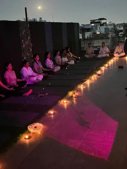 A wider view of our rooftop full moon ceremony. The combination of the open night sky, the city lights below, and the glow of the candles creates a truly magical and sacred space for our practice.