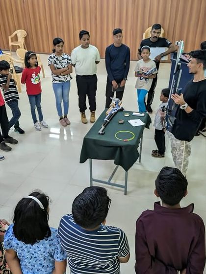 An overhead view of a safety and equipment demonstration for a group of students. Understanding the equipment is the first step to becoming a confident shooter.