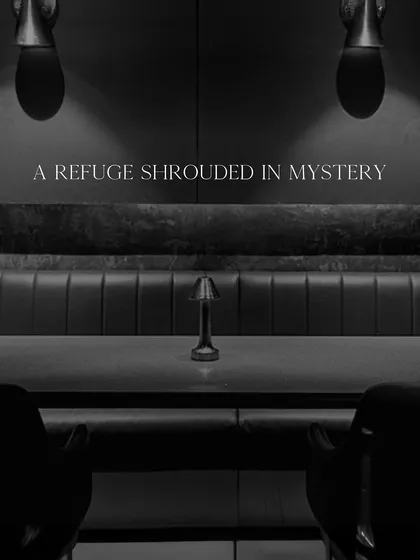 We are a refuge shrouded in mystery. This view captures the essence of our seating arrangement, designed for privacy and conversation under soft, focused lighting.