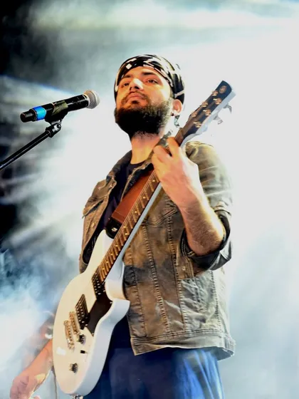 Lost in the music, on stage with my guitar. This is my happy place, where every note tells a story. This shot captures the soul of our Sufi rock and unplugged sets.