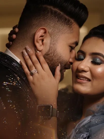 So much love in this picture. The glittery eye makeup and nails add a touch of sparkle to this beautiful engagement moment.